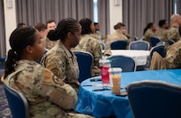 Attendees listen to speaker at summit.
