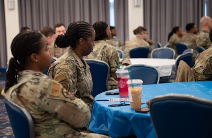 Attendees listen to speaker at summit.