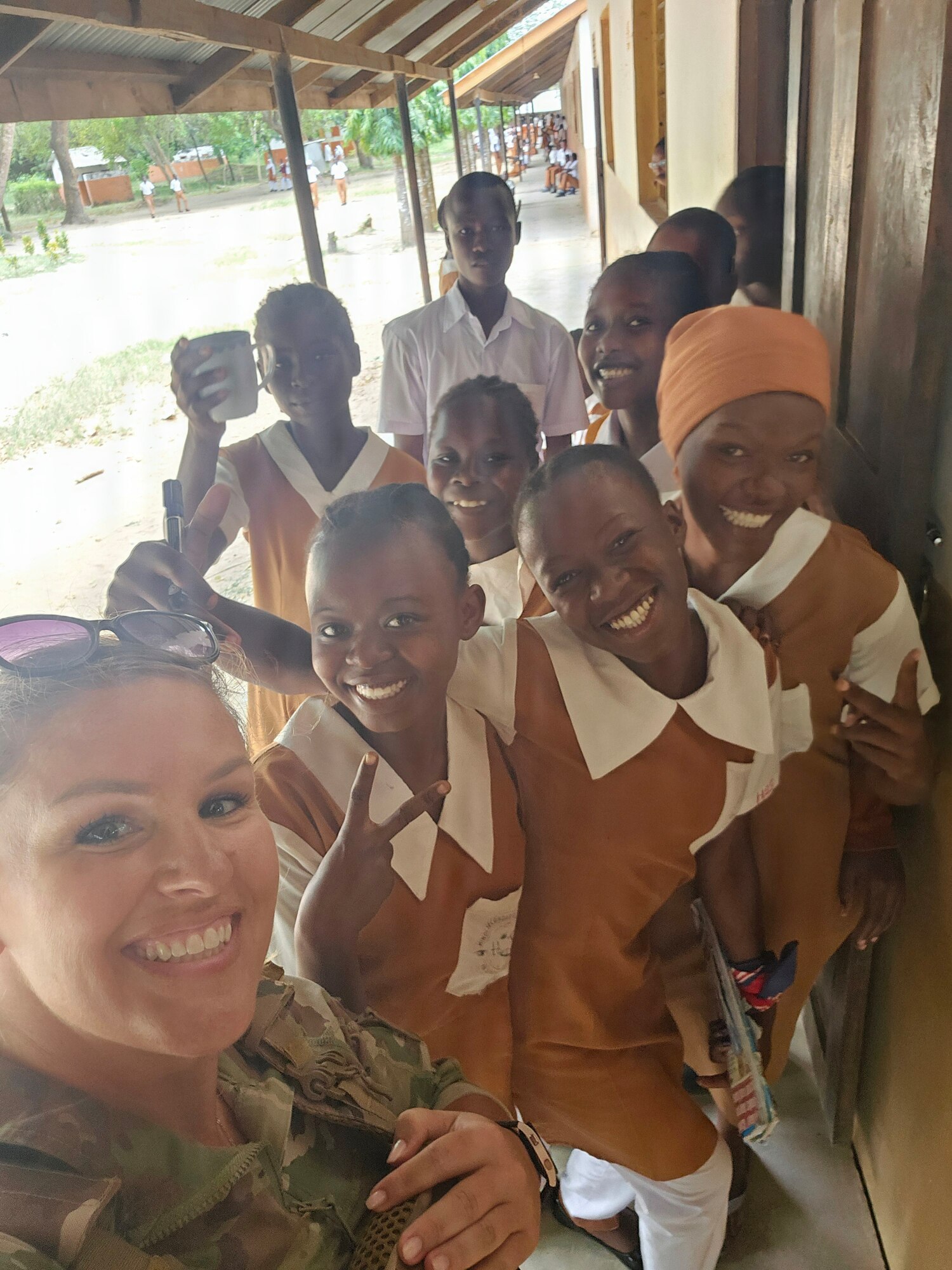 A photo of U.S. Air Force Master Sgt. Kelly Burton visiting a local high school in Kenya with Army Civil Affairs personnel.