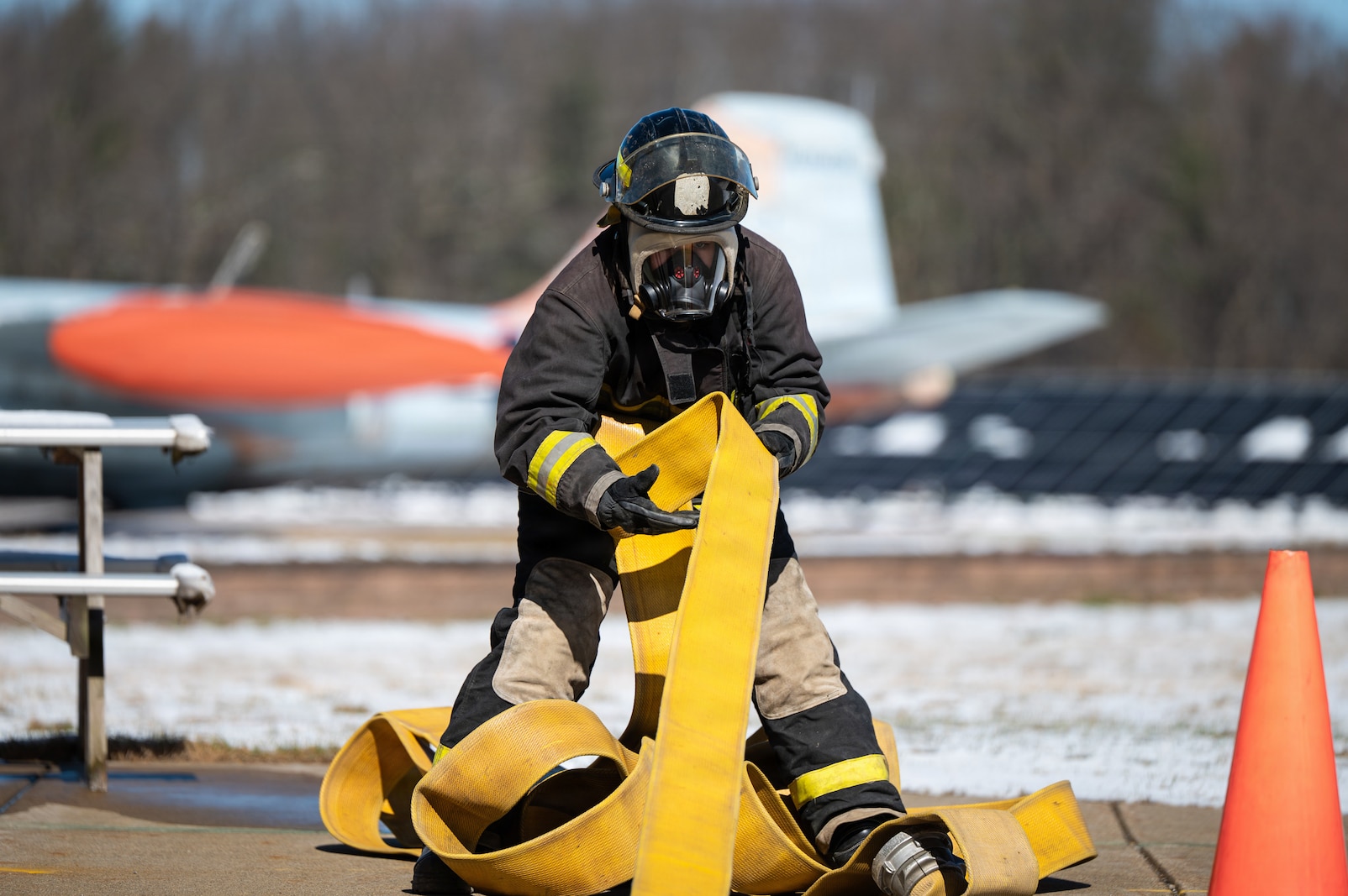 A photo of Emily Buffum, a student at the Stafford Technical Center, pulling in a line of hose during a SkillsUSA competition at the Vermont Air National Guard Base in South Burlington, VT, April 8, 2026.