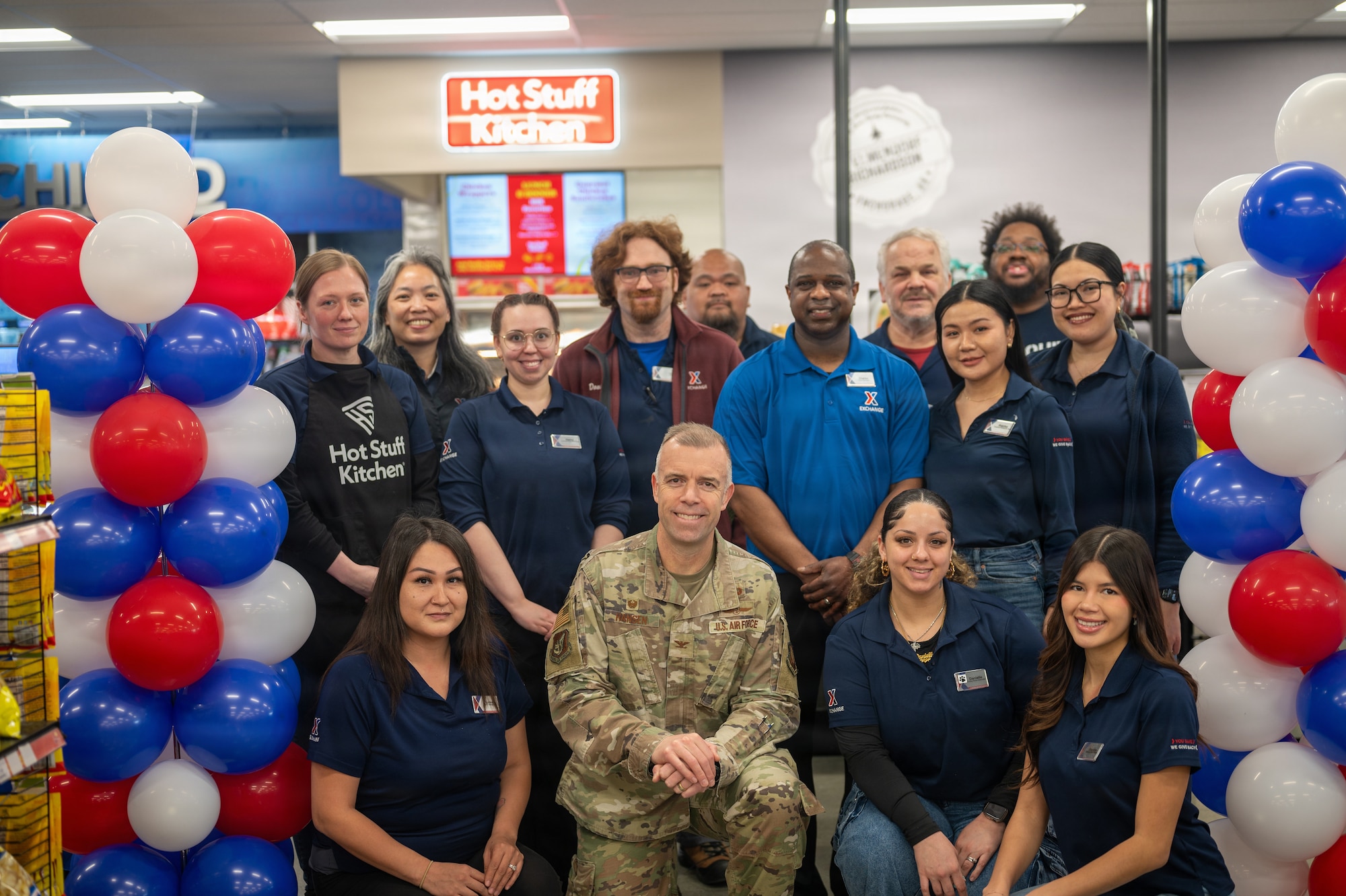 U.S. Air Force Col. Dustin Hansen, the 673d Wing Mission Support Group commander, stands with employees at the Elmendorf Express re-opening ceremony on Joint Base Elmendorf-Richardson, Alaska, April 23, 2026.