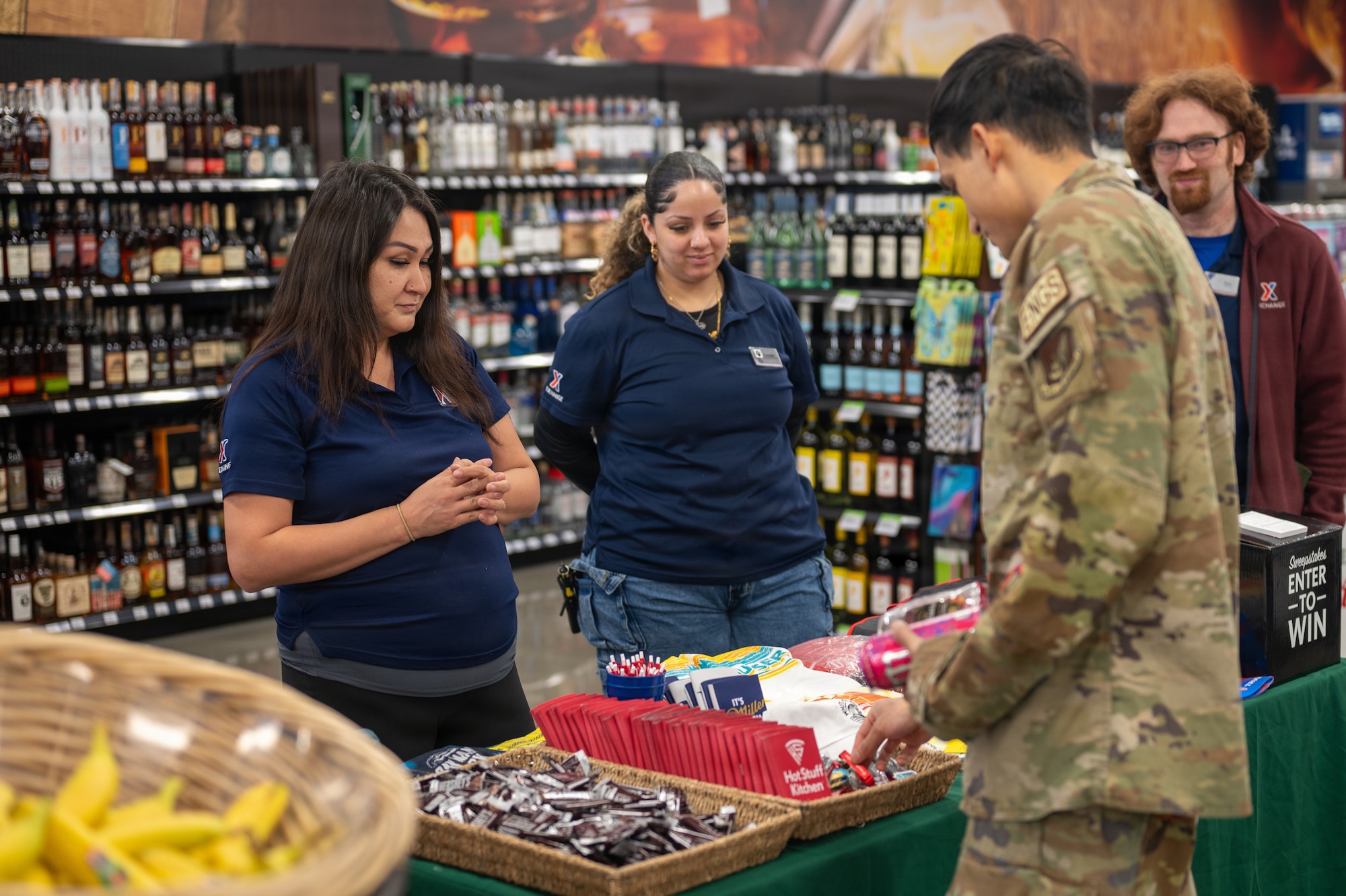 Employees at the Elmendorf Express pass out promotional gifts during their grand re-opening ceremony on Joint Base Elmendorf-Richardson, Alaska, April 23, 2026.