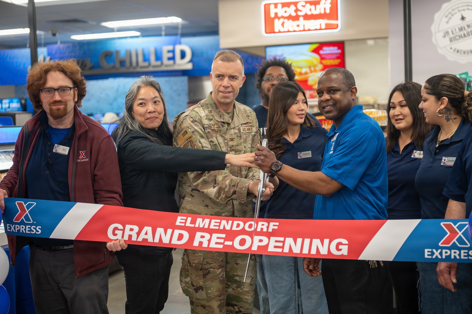 U.S. Air Force Col. Dustin Hanson, the 673d Wing Mission Support Group commander, helps cut the ribbon at the Elmendorf Express re-opening ceremony on Joint Base Elmendorf-Richardson, Alaska, April 23, 2026.