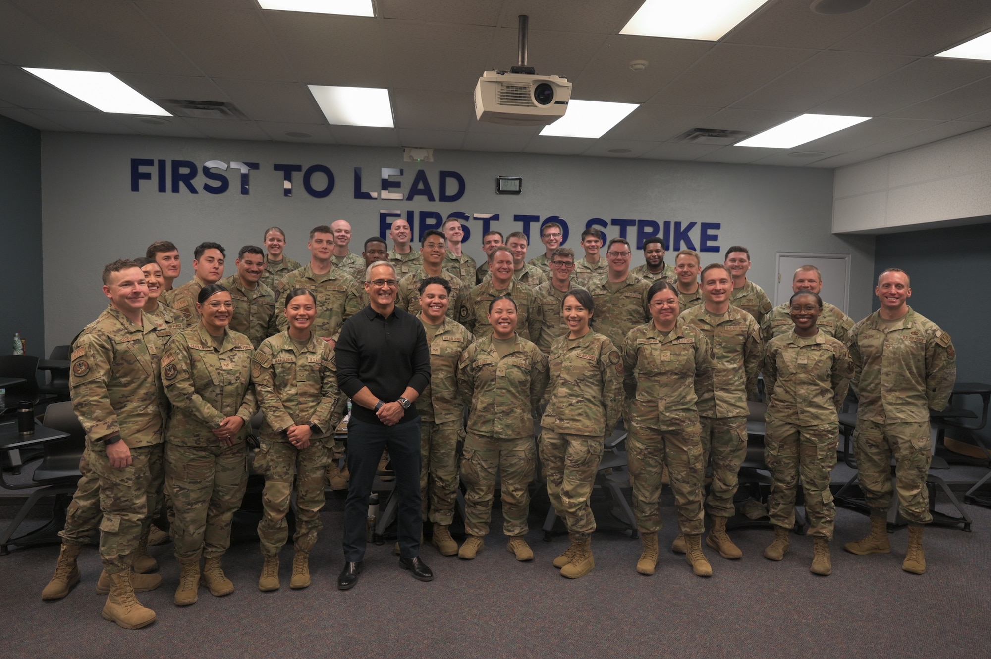 U.S. Air Force Senior Enlisted Advisor to the Chairman (Ret.) Ramón "CZ" Colón-López and students pose for a photo at the Airman Leadership School (ALS) during a visit to Kirtland Air Force Base, New Mexico, April 30, 2026. Colón-López, a career Pararescueman (PJ), the fourth Senior Enlisted Advisor to the Chairman (SEAC), and former USAF PJ/Combat Rescue Officer School Commandant at Kirtland from November 2006 to April 2009, spoke with the students about leadership, resilience, and his experiences serving a 33-year military career. (U.S. Air Force photo by Airman Maurice Casilla)