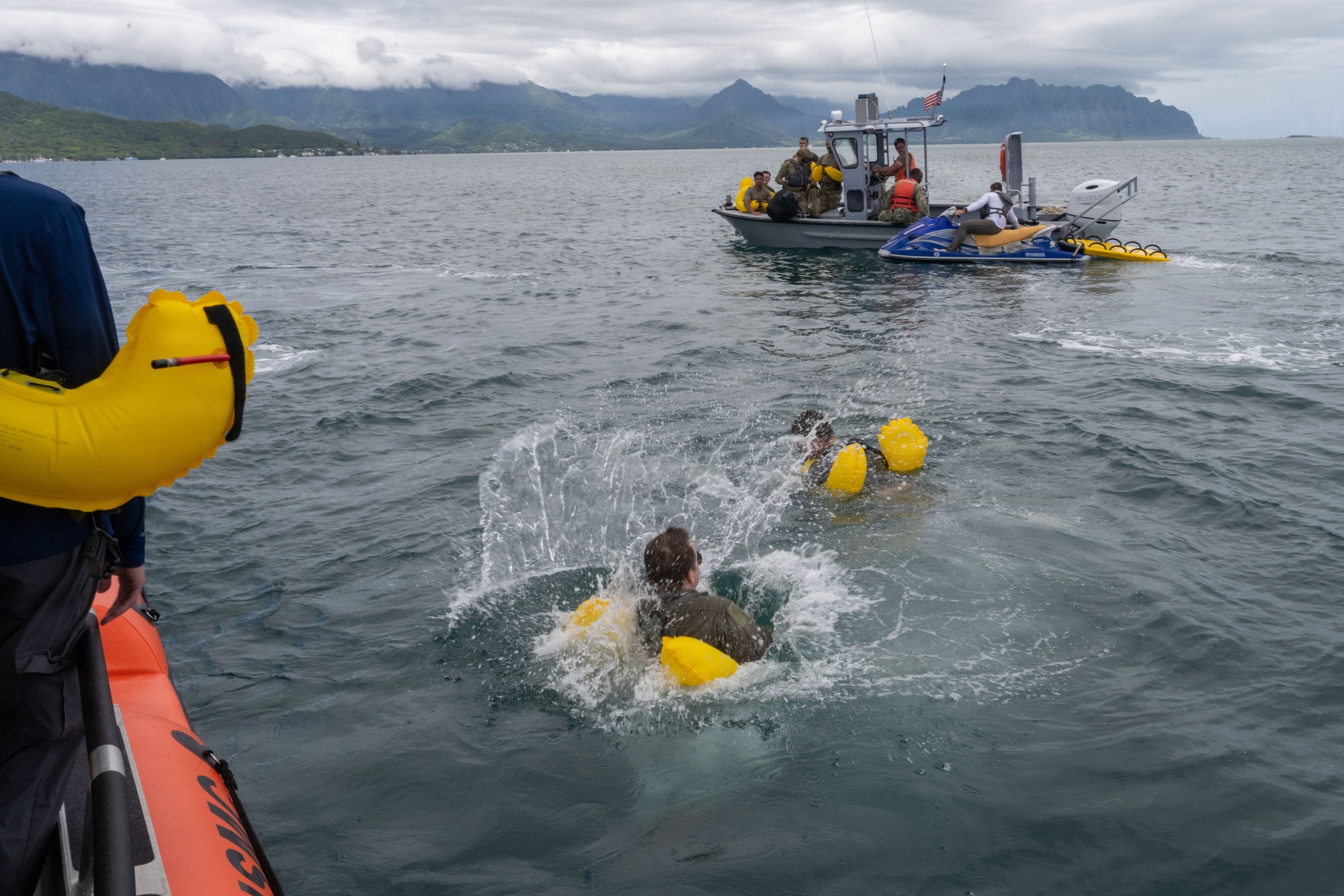 U.S. Air Force aircrew members jump into the water to begin their water survival training in the ocean.