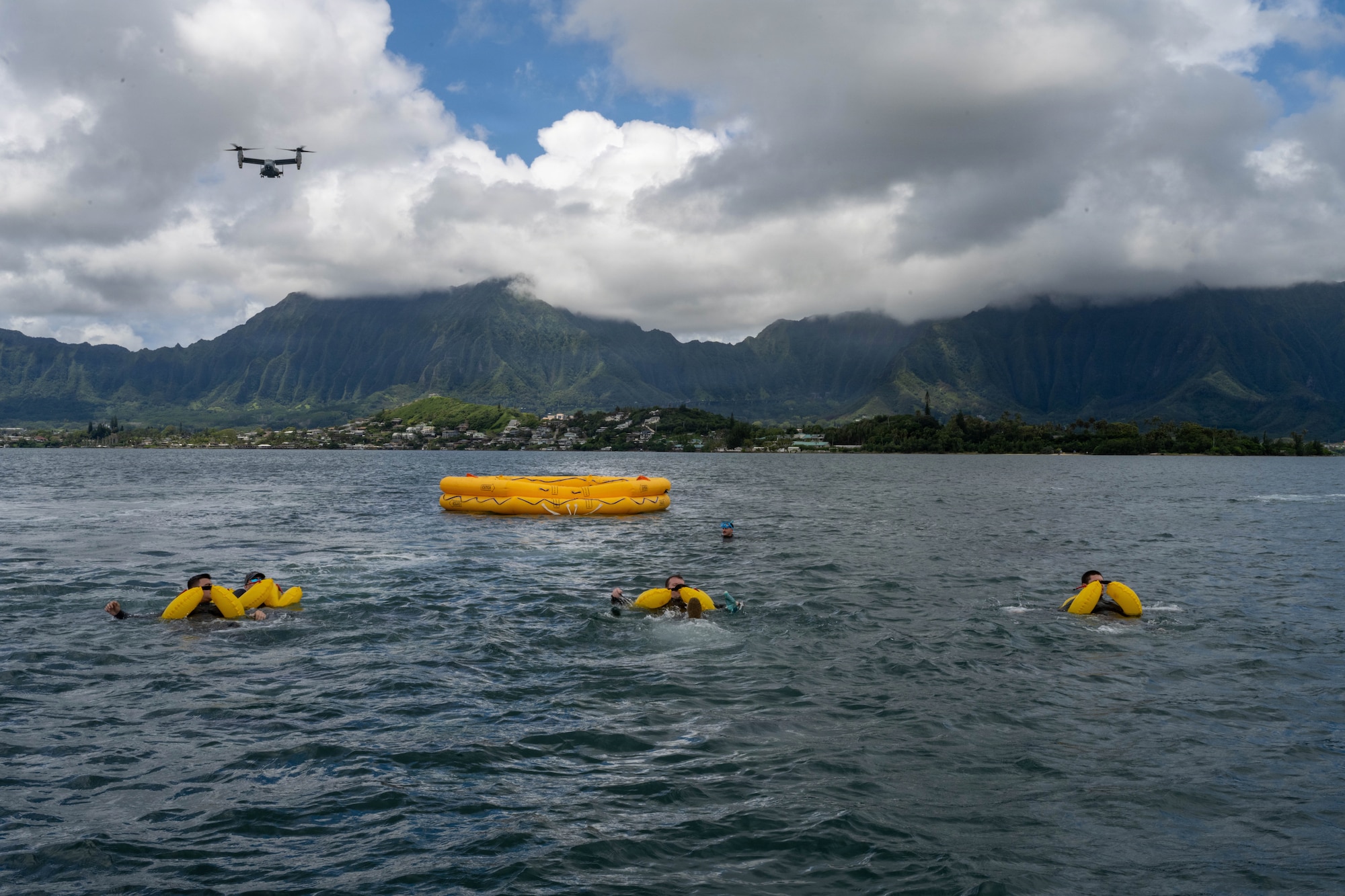 U.S. Air Force aircrew members swim toward a raft during their water survival training.