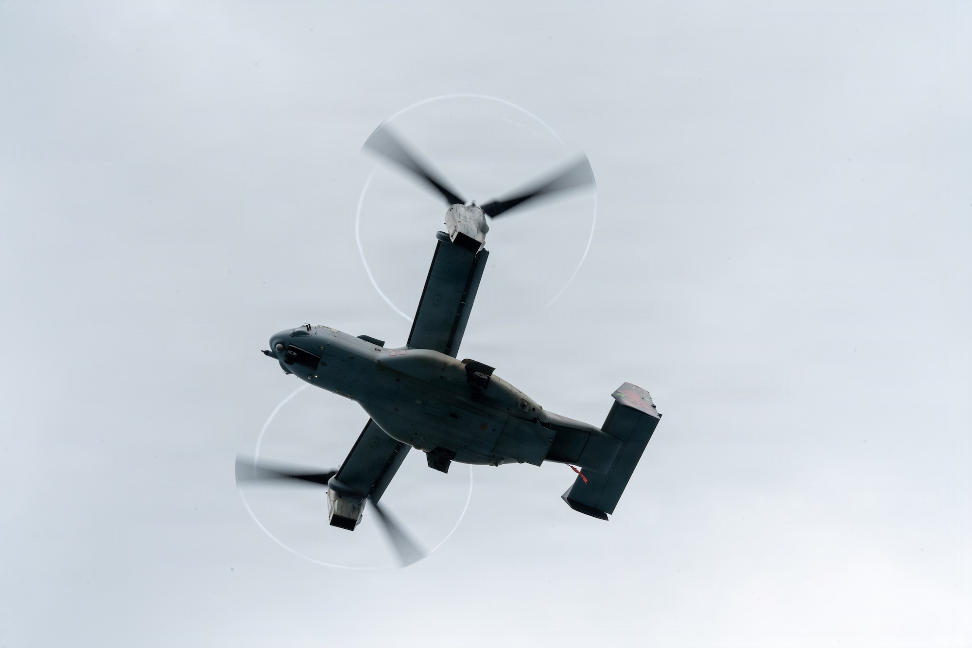 A U.S. Marine Corps MV-22B Osprey flies above the water survival training.