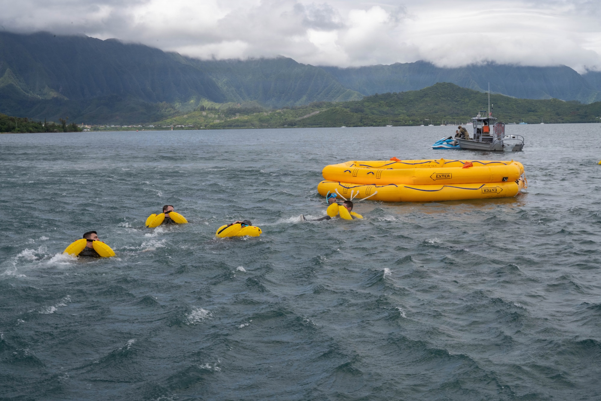 U.S. Air Force aircrew members swim toward a raft during their water survival training.