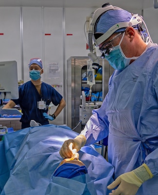 YOKOSUKA, Japan (March 9, 2026) — Capt. Matthew Keller, an ear, nose and throat and facial plastic surgeon assigned to U.S. Naval Hospital (USNH) Yokosuka, performs detailed nasal reconstruction under focused surgical lighting during a functional septorhinoplasty. USNH Yokosuka provides forward-deployed surgical capabilities that enhance warfighter readiness and improve patient care across the Indo-Pacific region. (U.S. Navy photo by Daniel Taylor/USNMRTC Yokosuka Public Affairs)
