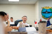 JOINT BASE PEARL HARBOR-HICKAM (April 8, 2026) — Rear Adm. Chris Cavanaugh, center, commander, Submarine Force, U.S. Pacific Fleet, provides opening remarks to various leaders during the 2026 Undersea Warfare Commanders’ Conference (USWCC) at Joint Base Pearl Harbor-Hickam, Hawaii, April 8, 2026. First held in 2018, this year’s conference theme was “Shaping the future: Moving forward quickly and collaboratively to assure our combined advantage in the undersea domain.” The USWCC conference included submarine force representatives from Australia, Canada, France, Japan, Republic of Korea, and Singapore. The multi-day event included briefings from each partner nation focused on force employment, combat readiness, interoperability, and integration of emerging technology such as unmanned systems and artificial intelligence. (U.S. Navy photo by Chief Mass Communication Specialist Omar A. Dominquez)