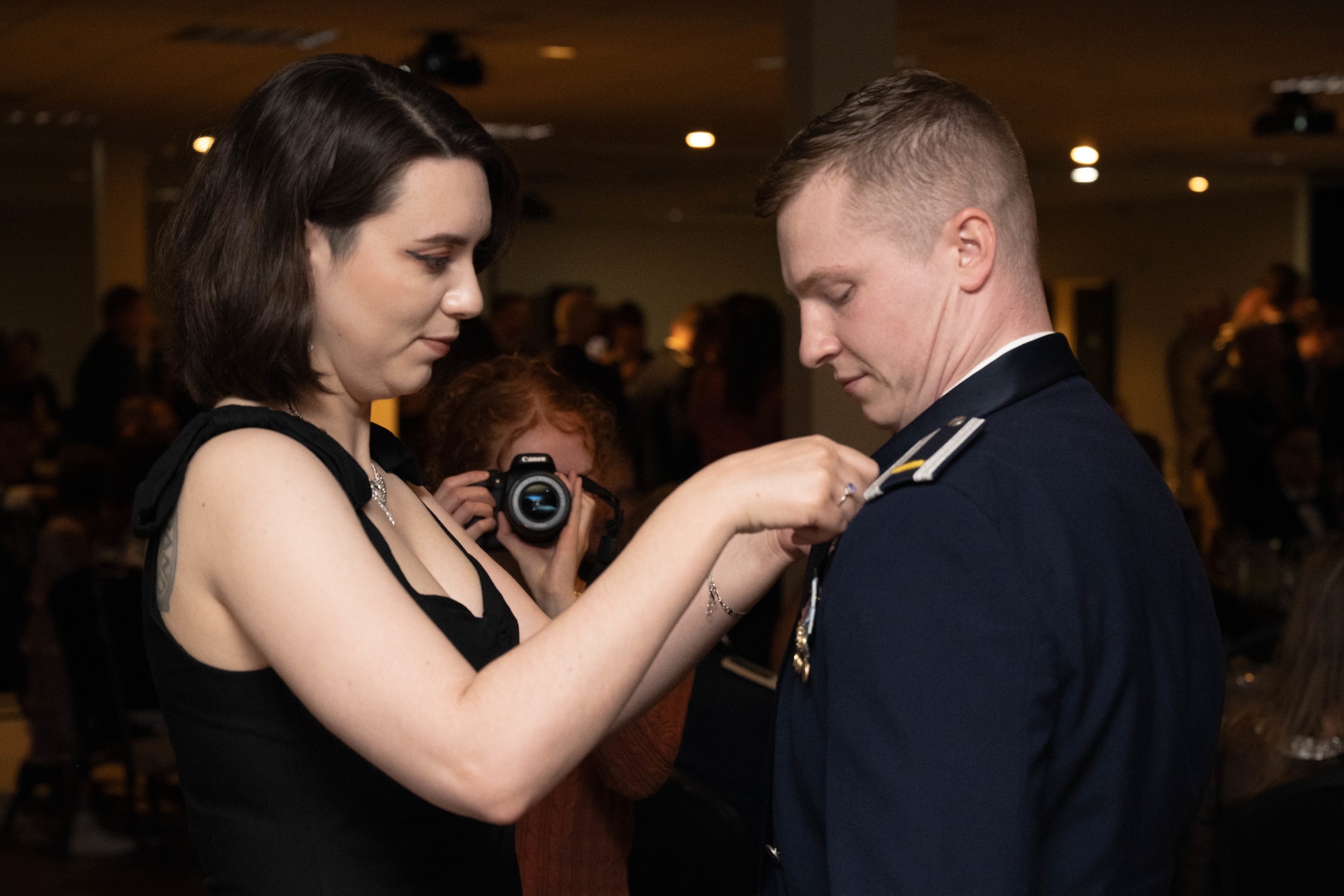 A loved one pins the silver wings onto U.S. Air Force 2nd Lt. Wyatt Peters, 47th Student Squadrons student pilot, during the graduation ceremony of Class 26-09 at Laughlin Air Force Base, Texas, April 30, 2026. Twenty-five U.S. Air Force officers were awarded silver wings, officially earning the aeronautical rating of pilot. (U.S. Air Force photo by Airman 1st Class Darryl Keith)