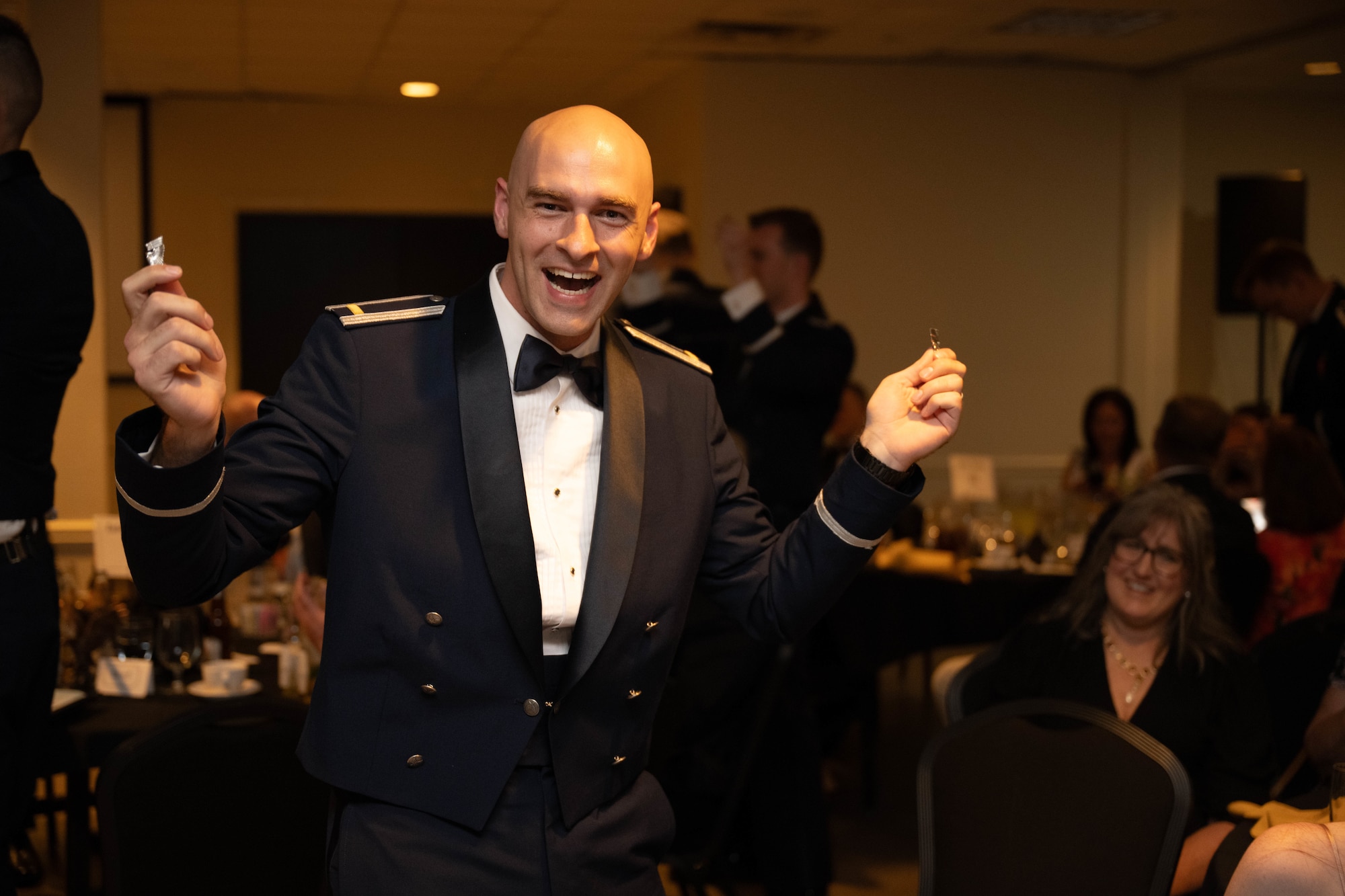 U.S. Air Force 2nd Lt. Wyatt Hickman, 47th Student Squadron student pilot, holds up their broken silver wings during the graduation ceremony of Class 26-09 at Laughlin Air Force Base, Texas, April 30, 2026. The breaking of silver wings is a tradition dating back to the U.S. Army Air Corps where a pilot's first wings are not to be worn but broken and given to a loved one. (U.S. Air Force photo by Airman 1st Class Darryl Keith)