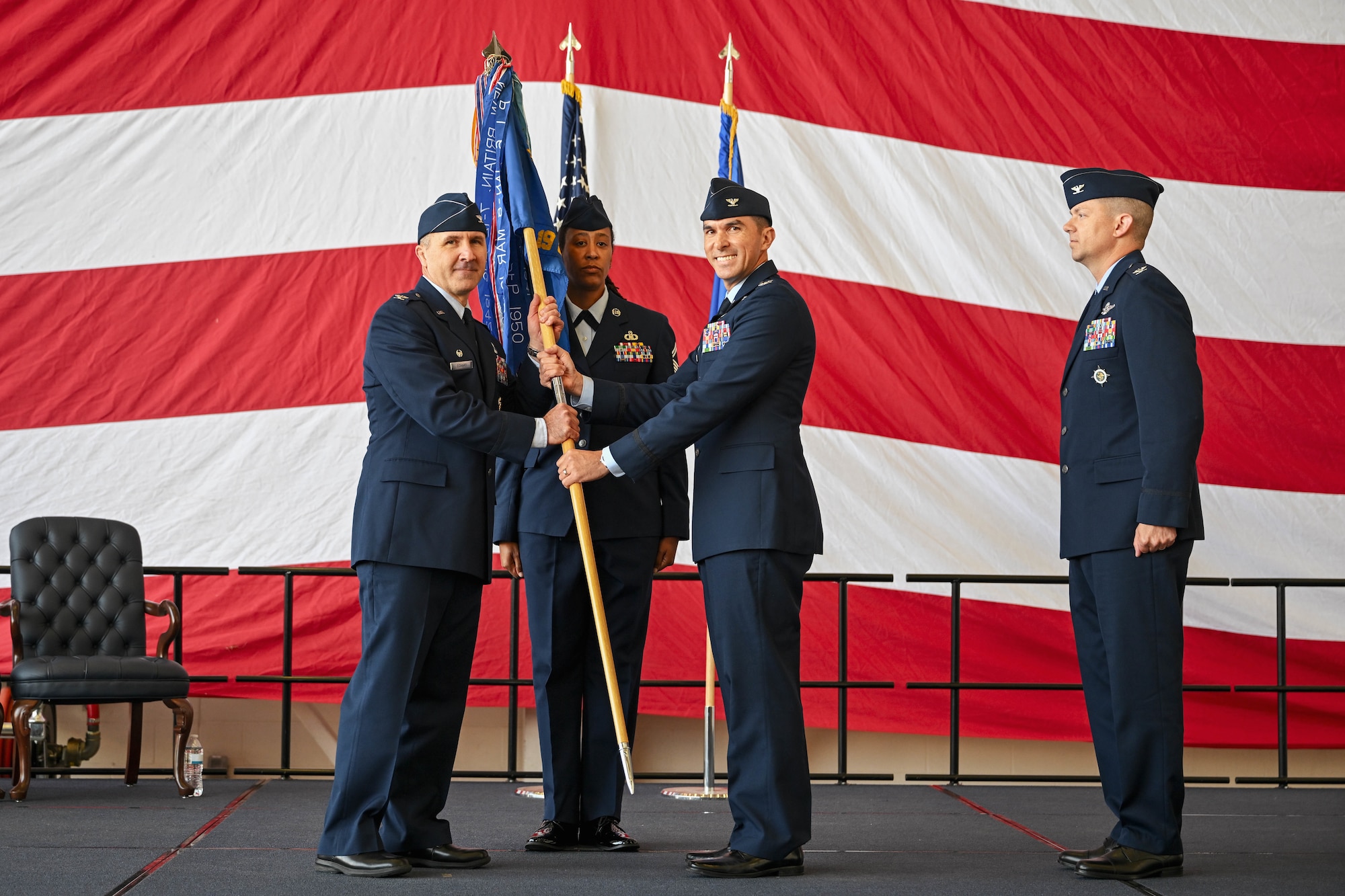 Airman passes a flag.