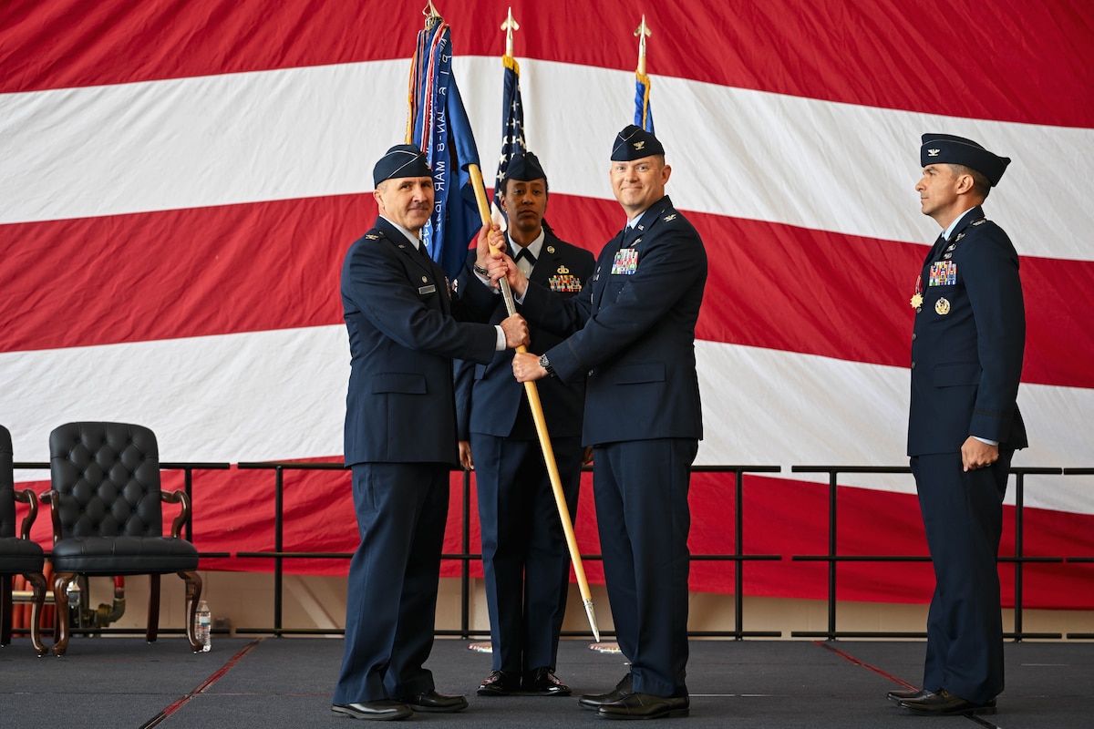 Airman passes a flag.