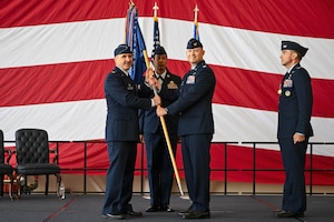 Airman passes a flag.