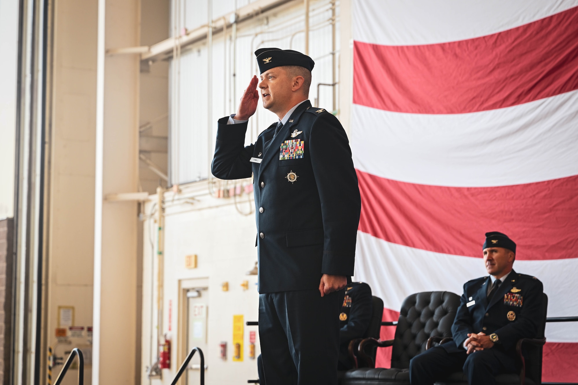 A man stands at attention rendering a salute.