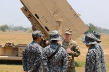 U.S. Army Capt. Melanie Rigoni, commander of Bravo Battery, 1st Battalion, 51st Air Defense Artillery Regiment, 7th Infantry Division/Multi-Domain Command - Pacific, talks to members of the Japan Air Self-Defense Force, about the Integrated Fires Protection Capability system during Exercise Balikatan 2026 at Naval Station Leovigildo Gantioqui, Philippines, April 26, 2026.
