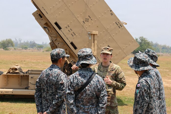 U.S. Army Capt. Melanie Rigoni, commander of Bravo Battery, 1st Battalion, 51st Air Defense Artillery Regiment, 7th Infantry Division/Multi-Domain Command - Pacific, talks to members of the Japan Air Self-Defense Force, about the Integrated Fires Protection Capability system during Exercise Balikatan 2026 at Naval Station Leovigildo Gantioqui, Philippines, April 26, 2026.