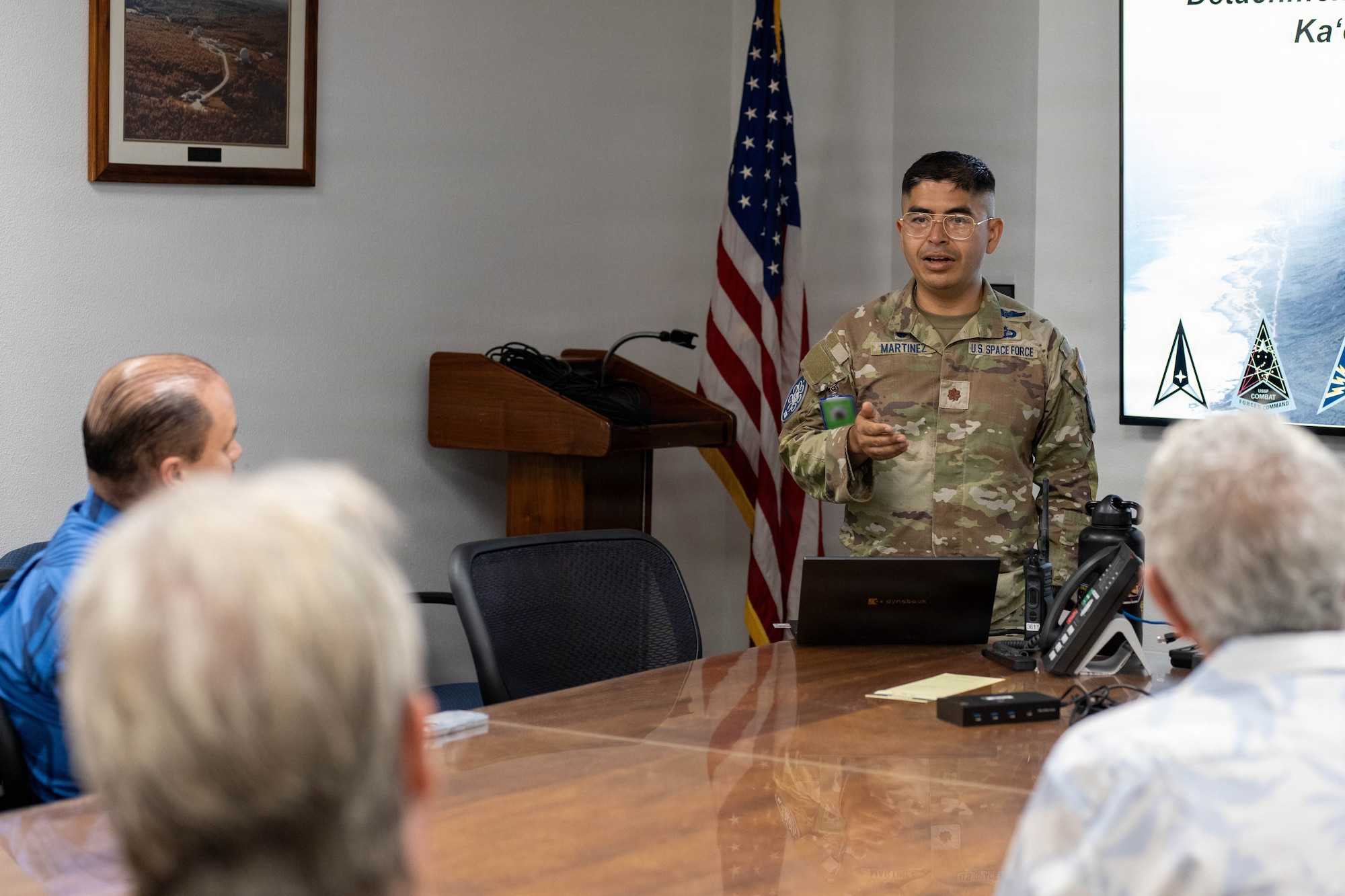 A U.S. Space Force Guardian briefs Team Hickam Honorary Commanders on the mission of Ka’ena Point Space Force Station.