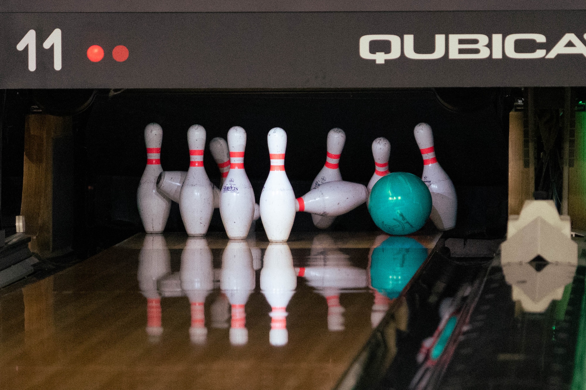 A teal bowling ball knocks down pins during the Sexual Assault Prevention and Response program's "Strike-out Sexual Assault" event on Joint Base Elmendorf-Richardson, Alaska, April 24, 2026. The event brought together military members and civilians in an approachable environment to build camaraderie while familiarizing personnel with SAPR resources outside of work. (U.S. Air Force photo by Airman 1st Class Keola Vischi)