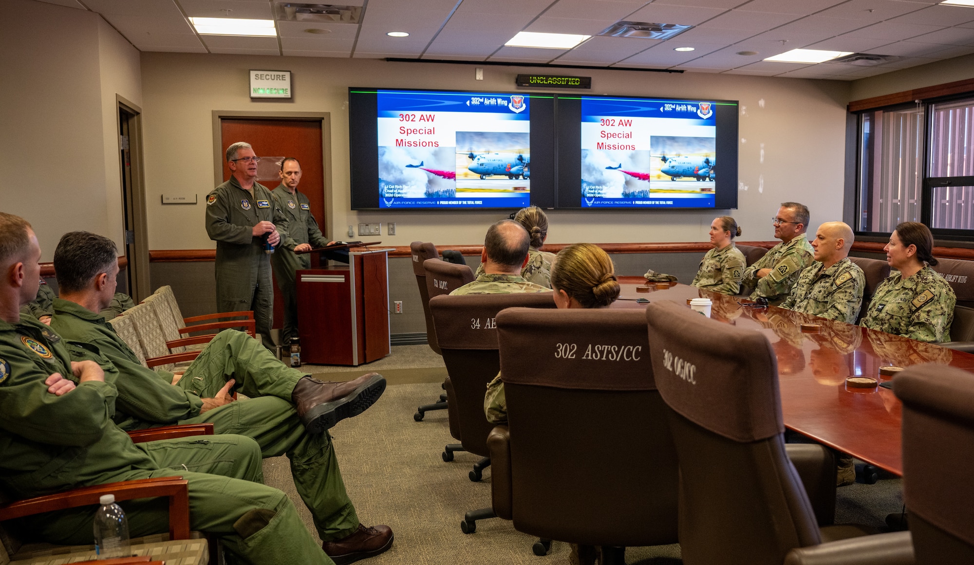 U.S. service members sit in a conference room