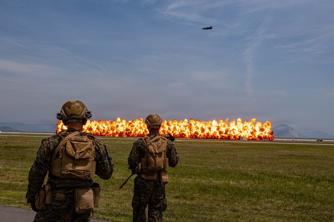 U.S. Marines with 1st Battalion, 25th Marine Regiment, 4th Marine Division, currently assigned to 3rd Marine Division under the Unit Deployment Program, observe an explosive charge detonation during Family Day at Marine Corps Air Station Iwakuni, May 2, 2026. MCAS Iwakuni’s Family Day gave U.S. and Japanese community members, their families, local orphanages, and individuals with special needs an opportunity to experience a smaller-scale Friendship Day during the air show rehearsal, highlighting the enduring strength of the U.S.-Japan Alliance. (U.S. Marine Corps Photo by Lance Cpl. Rylan Adcock)