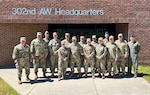 U.S. service members sit in a conference room