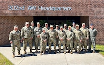 U.S. service members sit in a conference room