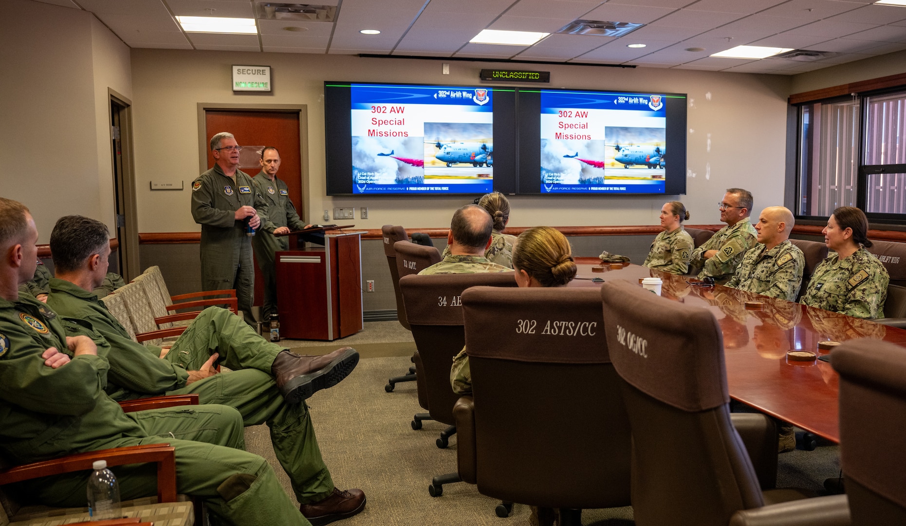 U.S. service members sit in a conference room