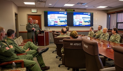 U.S. service members sit in a conference room