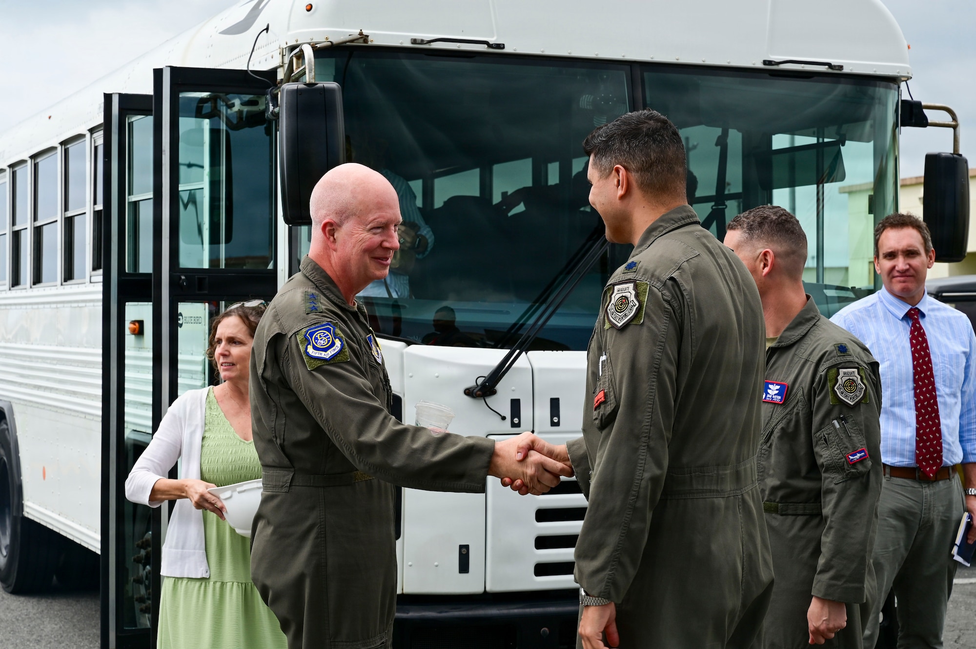 Two people greet and shake hands