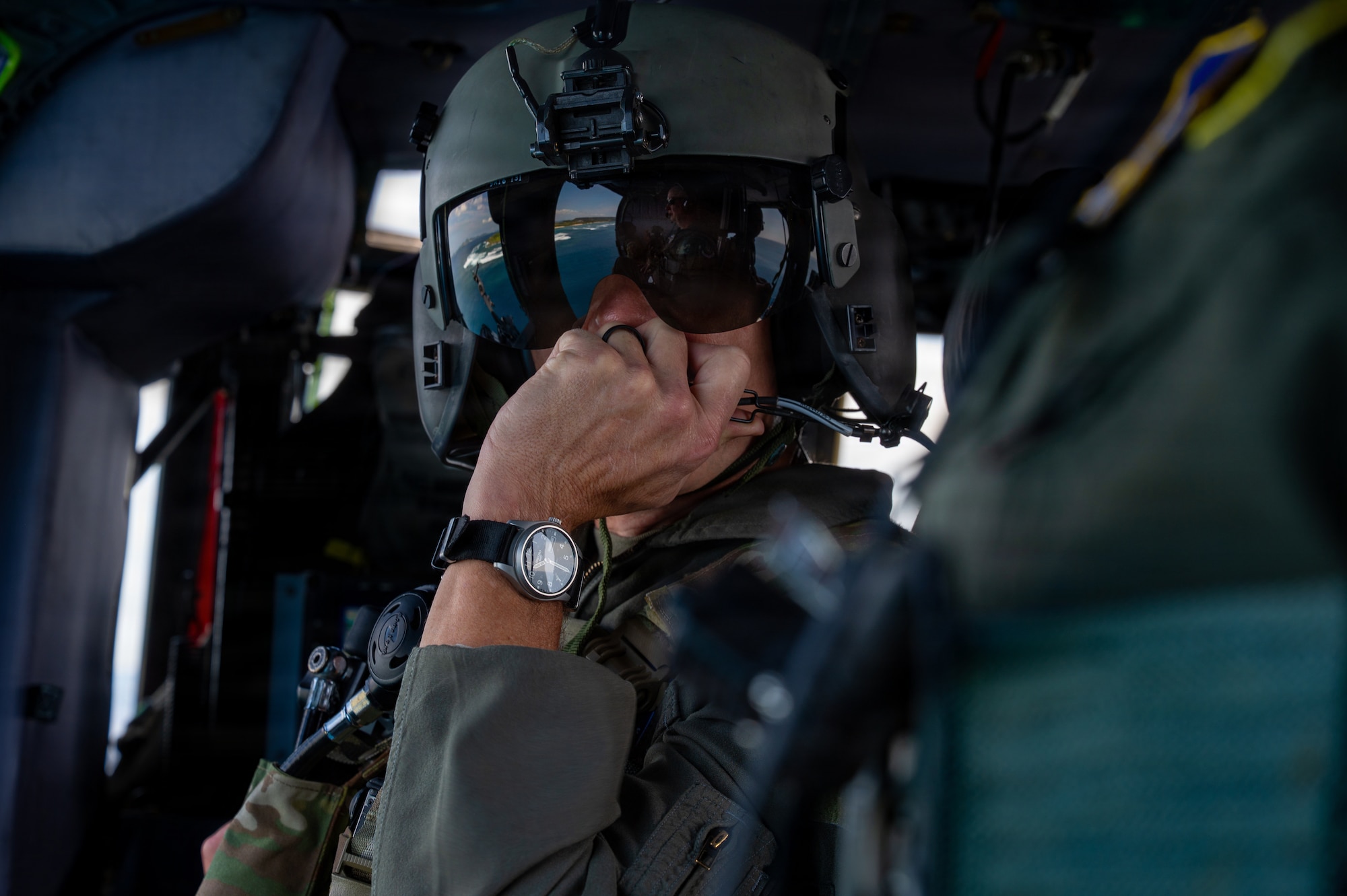A person in a helicopter talks over the radio