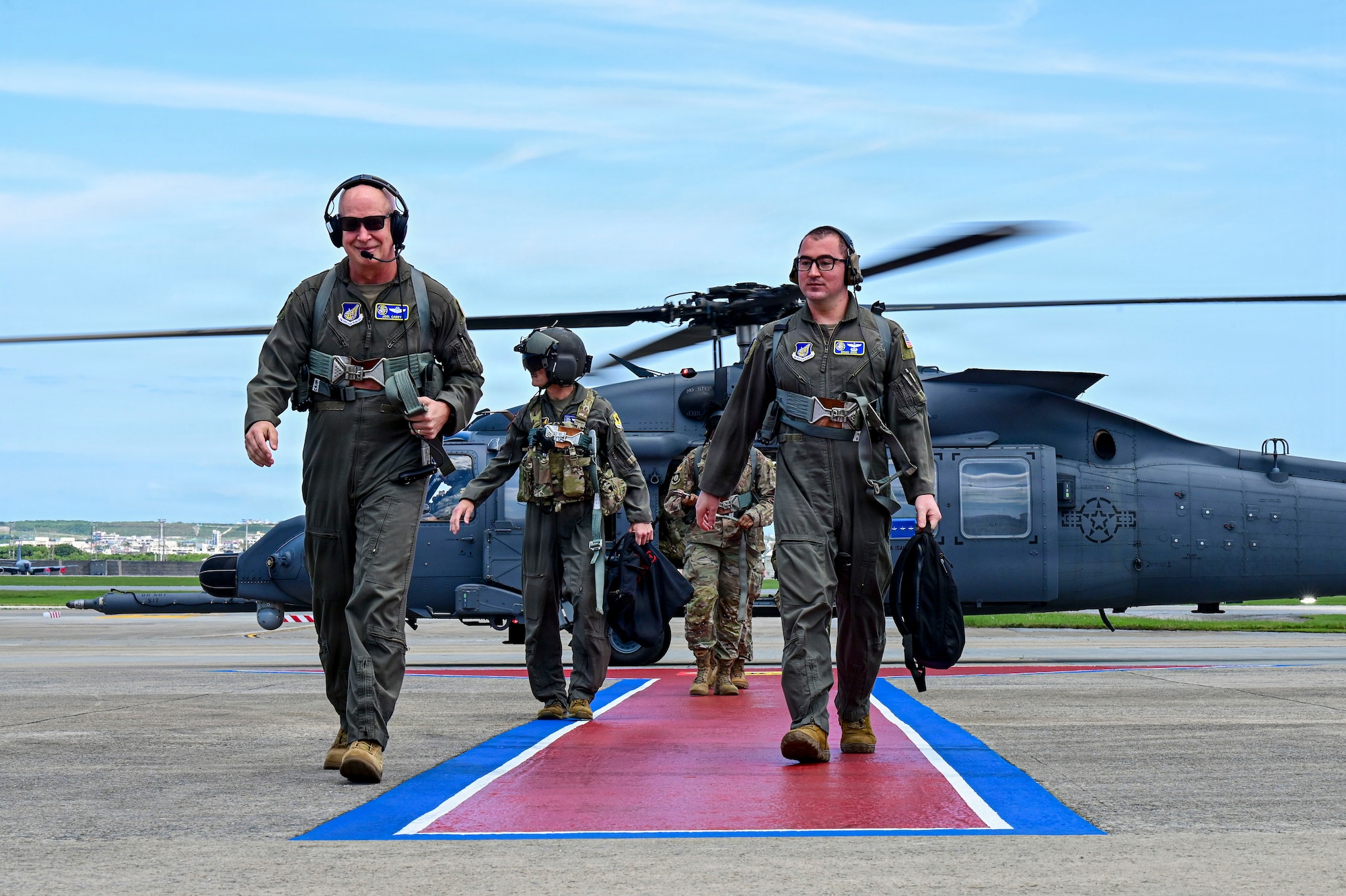 Group walks off of a helicopter after it lands