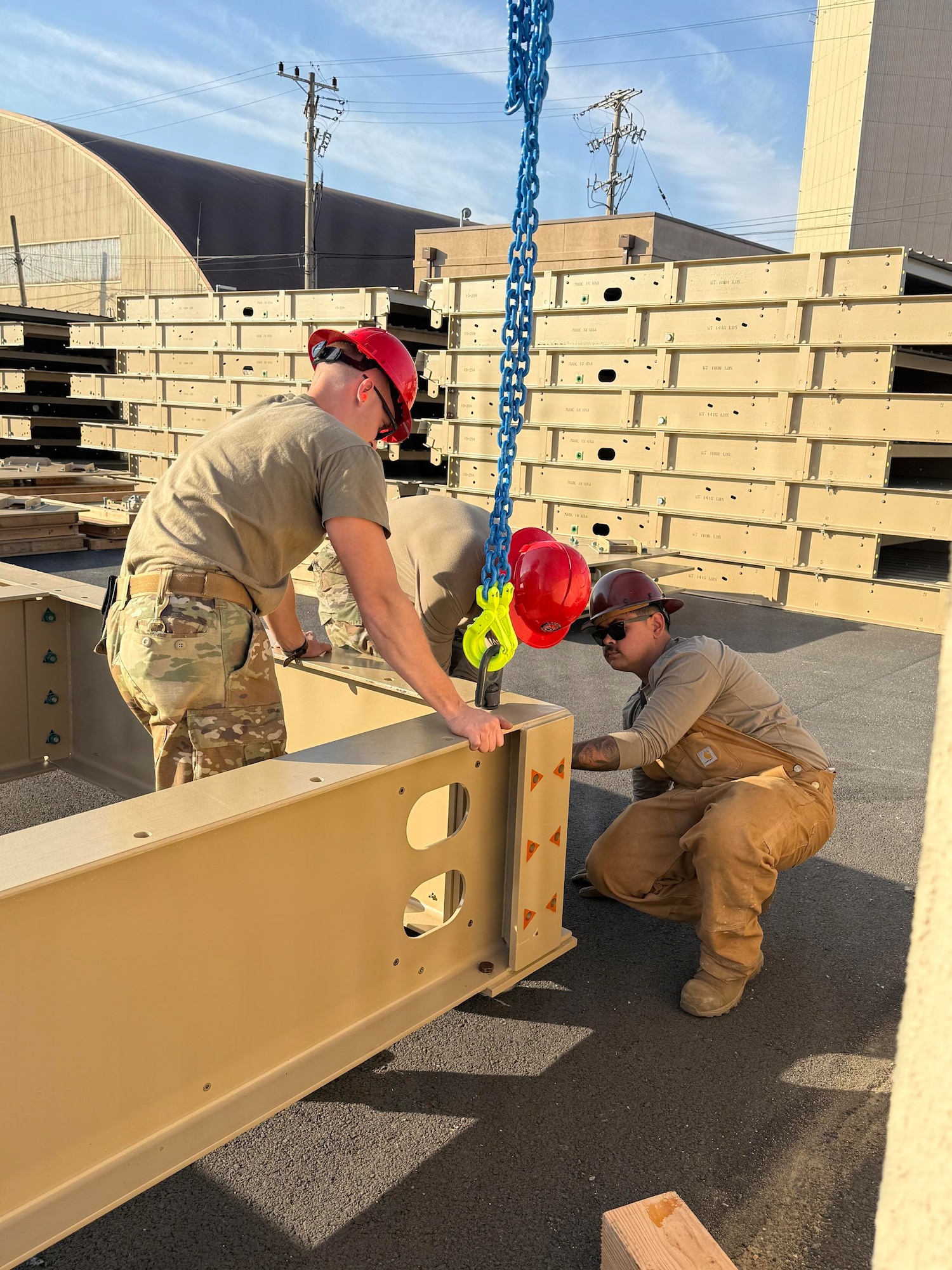 U.S. Airmen assigned to the 51st Civil Engineer Squadron position a steel beam during construction of an expeditionary storage and protection facility at Osan Air Base, Republic of Korea, 2026. The ESAP facility is a hardened, modular structure that provides protected storage for critical equipment while enhancing the base's readiness and ability to operate in contested environments. (Courtesy photo)