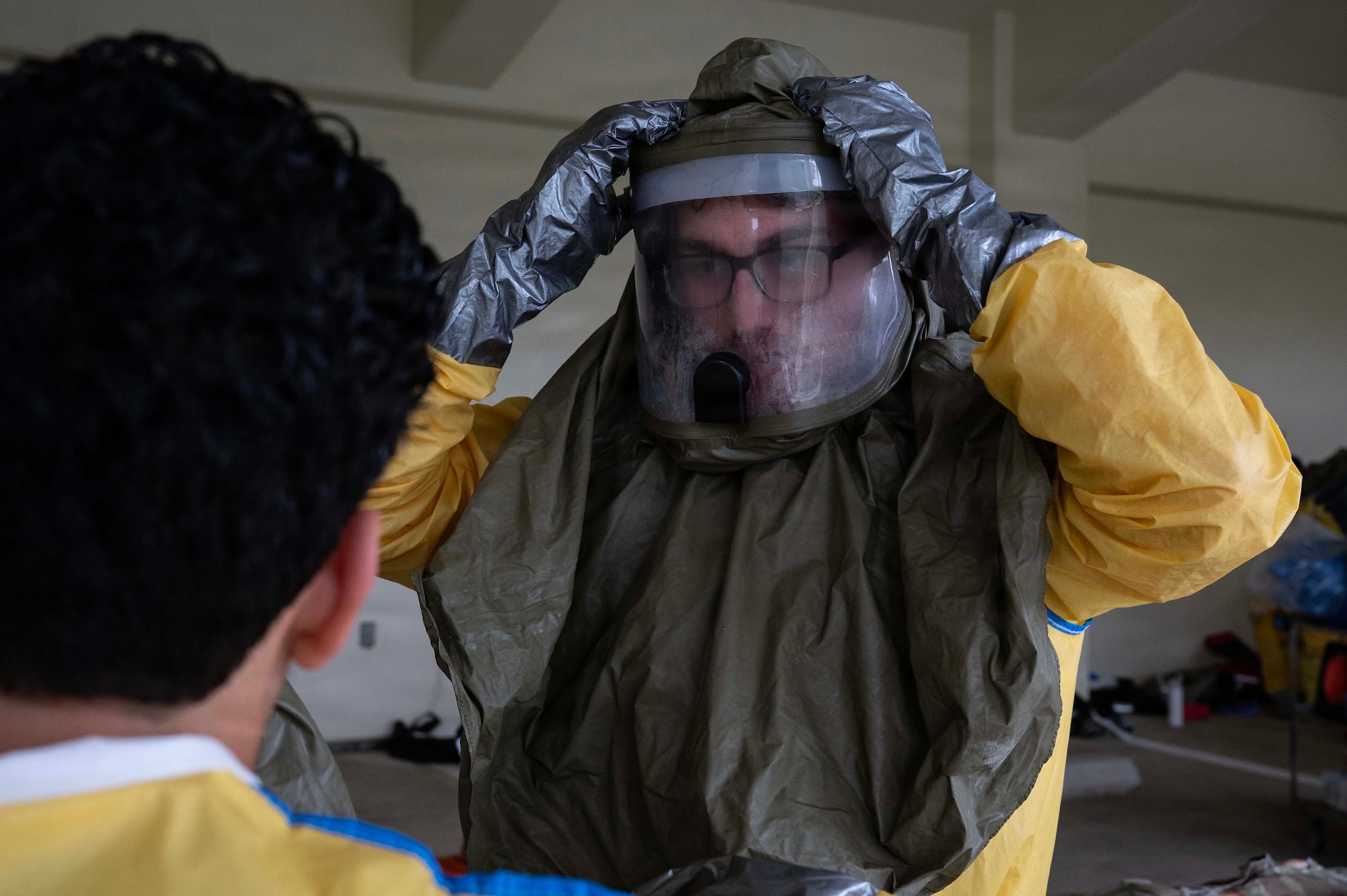 A person puts on their personal protective suit.