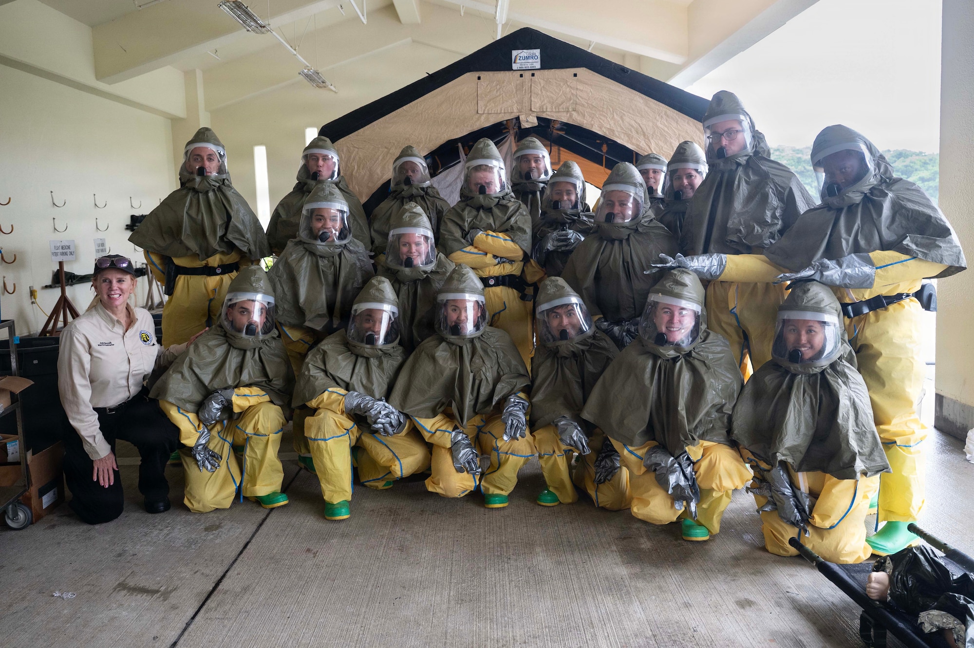 People pose for a photo in a group while in personal protective suits.
