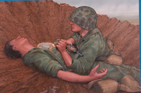 A painting by Morgan Wilbur depicts Hospital Apprentice First Class Robert E. Bush administering aid to a wounded Marine during the Battle of Okinawa in 1945. Bush, a U.S. Navy hospital corpsman, continued treating casualties after being wounded, actions for which he was later awarded the Medal of Honor. (U.S. Navy illustration by Morgan Wilbur)
