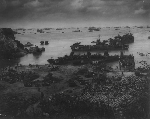 U.S. Navy landing craft and support vessels offload troops, vehicles, and supplies onto Okinawa during the early stages of the invasion in April 1945. The buildup of forces ashore was critical to sustaining combat operations during the Battle of Okinawa, the largest amphibious assault in the Pacific Theater. (U.S. Navy photo)