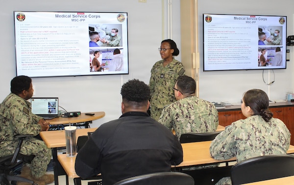 Lt. Kionna Myles, the Navy Medical Service Corps (MSC) Chief Liaison, speaks with hospital corpsmen during an enlisted-to-officer commissioning brief at Naval Medical Readiness and Training Command (NMRTC) Patuxent River. The brief, held in conjunction with a command visit by the Deputy Chief of the Medical Service Corps, offered Sailors a detailed roadmap for advancing their careers and transitioning into the officer ranks within the MSC's Healthcare Administration, Clinical Care, and Research and Applied Sciences pillars.