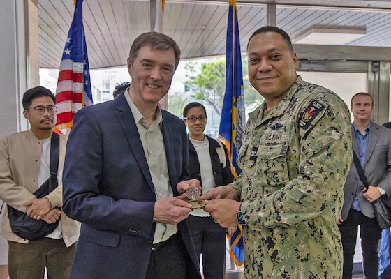 YOKOSUKA, Japan (April 15, 2026) — Capt. Torrin W. Velazquez, director of U.S. Naval Hospital (USNH) Yokosuka, presents his personal commanding officer’s coin to Steve Challinor, Steris nurse educator from Singapore, during the High-Level Disinfection and Sterilization (HLD/SPD) workshop at USNH Yokosuka, April 15. Challinor was recognized for supporting the first mainland Japan iteration of the workshop, which expanded regional access to specialized sterilization and high-level disinfection education for military and healthcare professionals serving throughout the Indo-Pacific. (U.S. Navy photo by Daniel Taylor/USNMRTC Yokosuka Public Affairs)