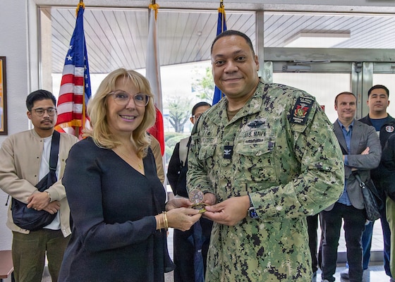 YOKOSUKA, Japan (April 15, 2026) — Capt. Torrin W. Velazquez, director of U.S. Naval Hospital (USNH) Yokosuka, presents his personal commanding officer’s coin to Annie Watt, Steris nurse educator from Australia, during the High-Level Disinfection and Sterilization (HLD/SPD) workshop at USNH Yokosuka, April 15. Watt was recognized for her instructional leadership and contributions to expanding operationally relevant reprocessing education for healthcare professionals across the Indo-Pacific region. (U.S. Navy photo by Daniel Taylor/USNMRTC Yokosuka Public Affairs)
