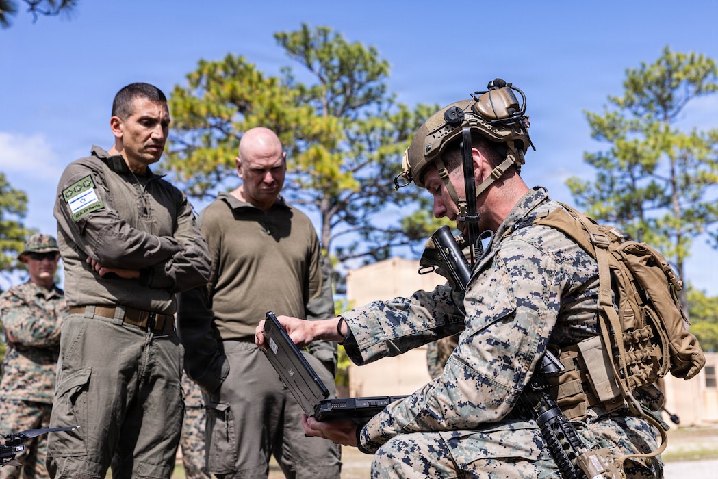 U.S. Marine Corps Sgt. Cooper Becker, a squad leader with 2nd Combat Engineer Battalion, 2nd Marine Division, conducts a Skydio X2D small unmanned aircraft system showcase to Israeli Defense Force soldiers Lt. Col. Ofir Samish, left and Col. Eli David, during a Marine Corps Combat Readiness Evaluation on Marine Corps Base Camp Lejeune, North Carolina, April 27, 2026. The IDF engaged with 2nd CEB to exchange engineer capabilities and small unmanned aerial systems to better understand the similarities and differences between both armed forces. Marines participated in a MCCRE to be assessed on unit combat readiness and ability to execute mission critical tasks in preparation for future operations and deployments. (U.S. Marine Corps photo by Cpl. Judith Ann Lazaro)