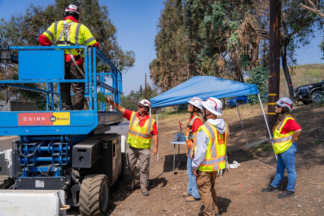 Dan Juracek, safety and occupational health specialist with the Fort Worth District (center) trains quality assurance personnel on the proper use of the scissor lift at the Temporary Debris Staging and Reduction site at Will Rogers Park, June 26, 2025 in Pacific Palisades, California.