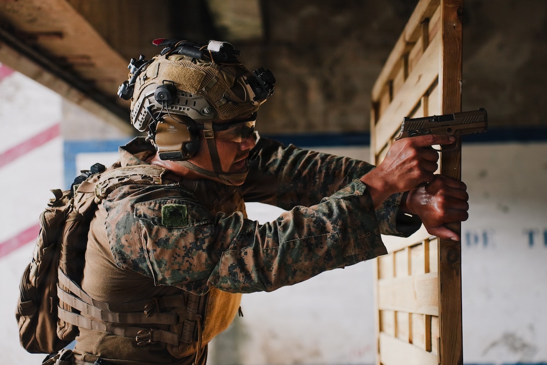 A U.S. Marine Corps rifleman with India Company, Battalion Landing Team 3/6, 22nd Marine Expeditionary Unit (Special Operations Capable), engages a target with an M18 pistol during a stress shoot event as part of Tres Kolos 26 at Fort-De-France, Martinique, April 23, 2026. Participation in Tres Kolos 26 enhances interoperability with partner nations, reinforces longstanding security relationships, and improves combined readiness to respond to crises across the region. U.S. military forces are deployed to the Caribbean in support of U.S. Southern Command mission objectives and the president's priorities to strengthen regional security, disrupt illicit drug trafficking, and protect the homeland. (U.S. Marine Corps photo)