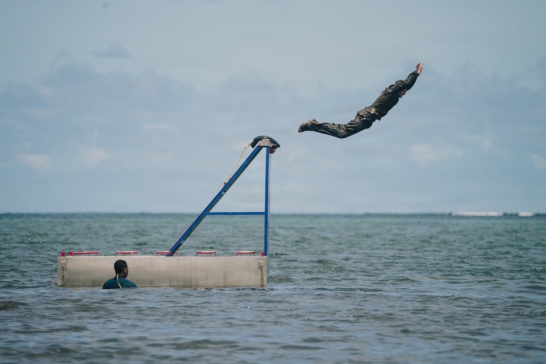 A U.S. Marine Corps rifleman with India Company, Battalion Landing Team 3/6, 22nd Marine Expeditionary Unit (Special Operations Capable), jumps from an obstacle during a water obstacle course event as part of Tres Kolos 26, near Le Francois, Martinique, April 22, 2026. Participation in Tres Kolos 26 enhances interoperability with partner nations, reinforces longstanding security relationships, and improves combined readiness to respond to crises across the region. U.S. military forces are deployed to the Caribbean in support of U.S. Southern Command mission objectives and the president's priorities to strengthen regional security, disrupt illicit drug trafficking, and protect the homeland. (U.S. Marine Corps photo)