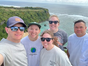 U.S. Air Force Airmen attending Noncommissioned Officer Academy at Kadena Air Base, Japan, pose for a photo during a trip to Okinawa’s Miyagi Islands on March 22, 2026. During the outing, the group responded to an off-duty emergency at Ikei Beach, applying Tactical Combat Casualty Care training to assist an injured local man until emergency responders arrived. (U.S. Air Force courtesy photo)