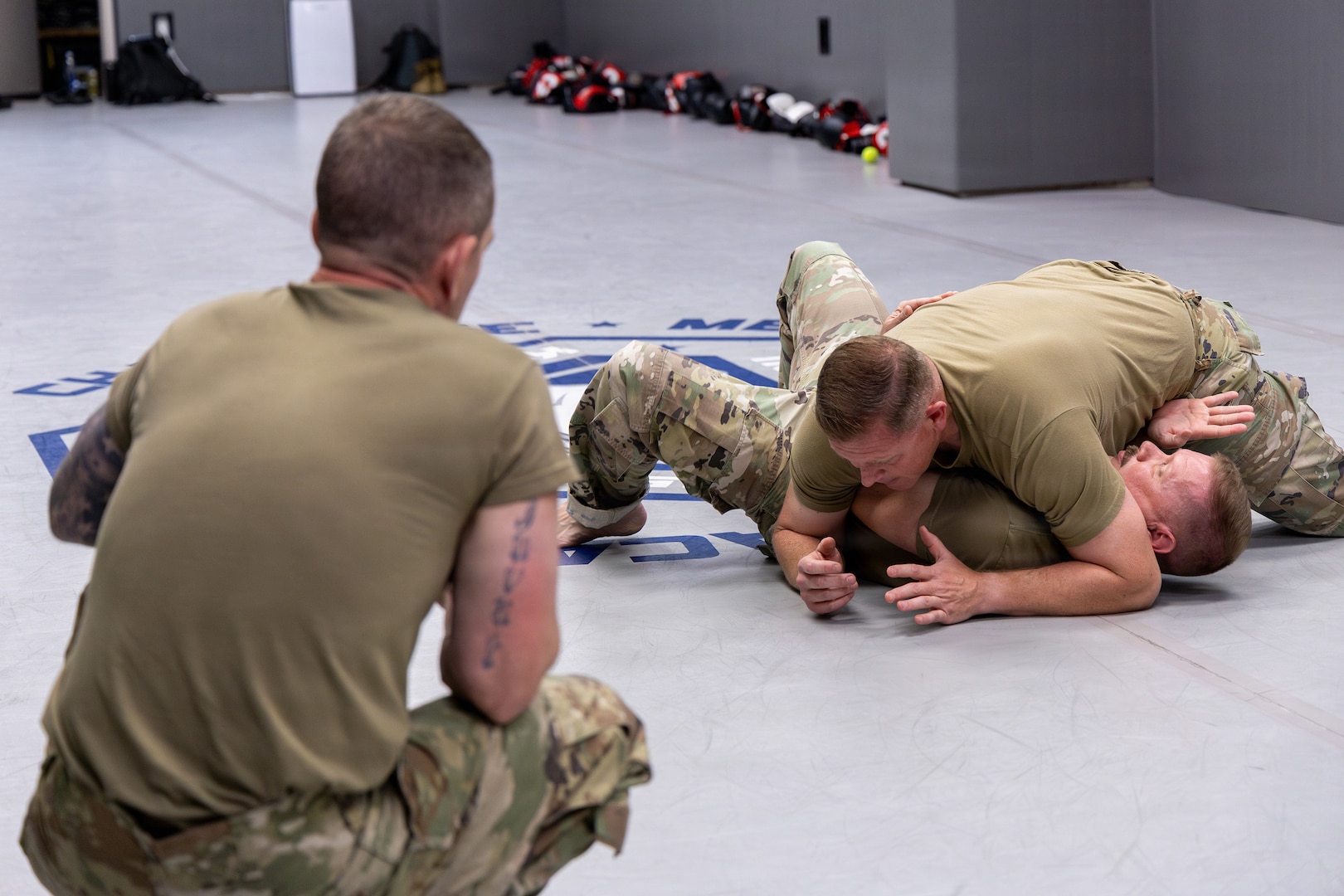 U.S. Air Force Master Sgt. Daniel K. Ayers, 145th Security Forces Squadron, or SFS, unit training manager, top, demonstrates the side-mount guard position on Master Sgt. Steven T. Johnson, 145th SFS instructor, bottom, at the Charlotte-Mecklenburg Police Department Training Academy, Charlotte, N.C., May 2, 2026.