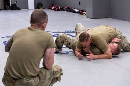 U.S. Air Force Master Sgt. Daniel K. Ayers, 145th Security Forces Squadron, or SFS, unit training manager, top, demonstrates the side-mount guard position on Master Sgt. Steven T. Johnson, 145th SFS instructor, bottom, at the Charlotte-Mecklenburg Police Department Training Academy, Charlotte, N.C., May 2, 2026.