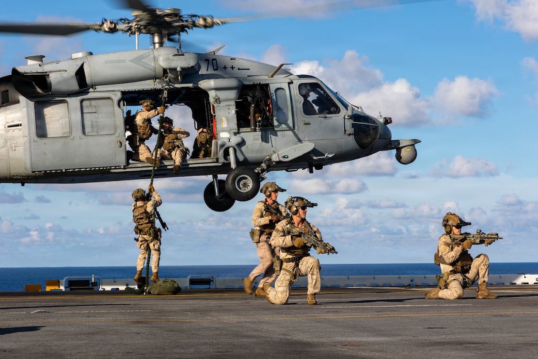 U.S. Marines with Maritime Special Purpose Force, 22nd Marine Expeditionary Unit (Special Operations Capable), fast rope from a Navy MH-60S Sea Hawk helicopter, assigned to Helicopter Sea Combat Squadron (HSC) 26, aboard Wasp-class amphibious assault ship USS Iwo Jima (LHD 7) while underway in the Caribbean Sea, April 24, 2026.