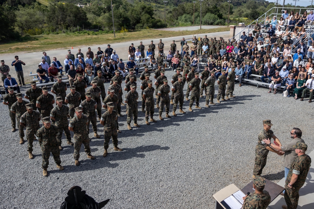 U.S. Marines and Sailors stand in formation for the graduation ceremony for Basic Reconnaissance Course 2-26 with Reconnaissance Training the Company, at Marine Corps Base Camp Pendleton, Calif., April 3, 2026. Employed as an element of the Marine Air-Ground Task Force, Reconnaissance Marines operate in specialized teams to provide timely information to the supported commander to shape and influence the battlefield. (U.S. Marine Corps photo by Lance Cpl. Jonathan Sherchand)